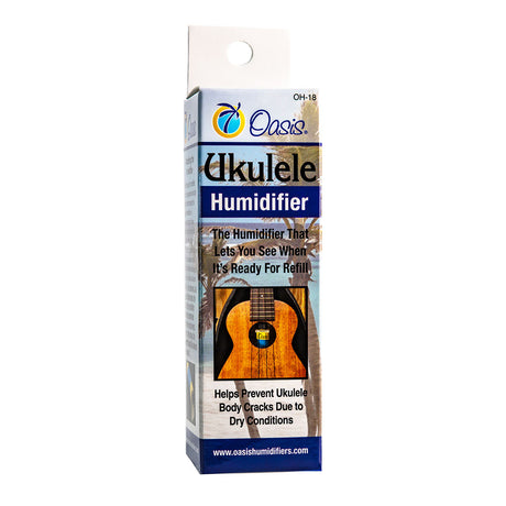 The image shows the Oasis Ukulele Humidifier (Model OH-18), a care accessory designed to prevent cracks in ukuleles caused by dry conditions. It fits inside the ukulele’s sound hole and features a visual indicator to show when it needs refilling. Ideal for maintaining proper humidity and protecting wooden ukuleles, especially in dry climates or heated indoor environments. Brand website: www.oasishumidifiers.com.