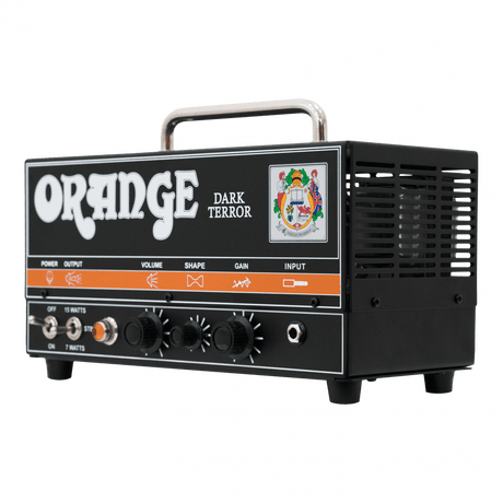 The image shows an Orange Dark Terror guitar amplifier head, a compact, high-gain tube amp with a classic orange and black design. It features a wattage toggle switch (OFF/7W/15W), three knobs (Volume, Shape, Gain), an input jack, side vents, a metal handle, and the iconic Orange logo, making it a portable amp head ideal for heavy rock and metal tones.