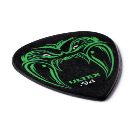 Guitar pick with green dragon design and 'Ultex' branding on a white background