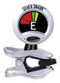 The image shows a Silver Snark clip-on guitar tuner with a metallic clip and circular display. The screen features a tuning meter with red, yellow, and green segments and displays the letter "E" indicating the detected note. The clip attaches to the instrument's headstock, and a small button is visible, likely for power or mode. This chromatic tuner detects vibrations through the instrument, making it a popular, portable accessory for string players.