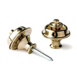 A pair of guitar straplocks with a brass finish on a white background
