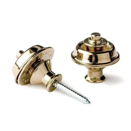 A pair of guitar straplocks with a brass finish on a white background