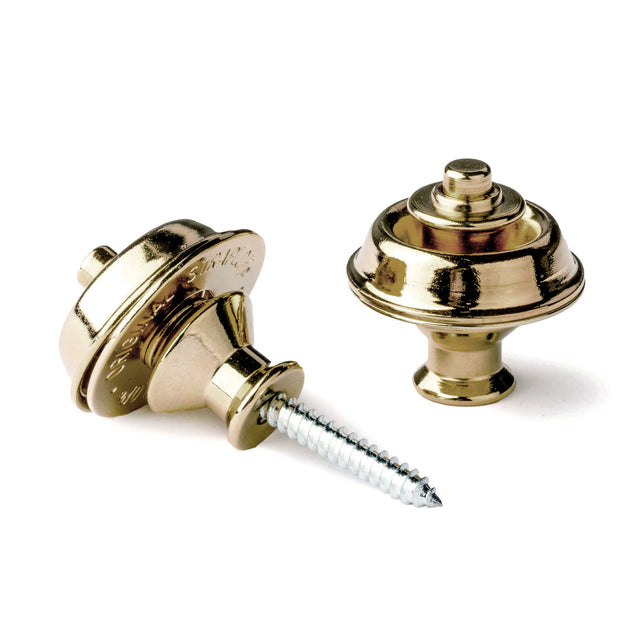 A pair of guitar straplocks with a brass finish on a white background