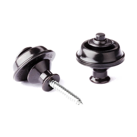 A pair of guitar straplocks with a black finish on a white background