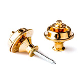 A pair of guitar straplocks with a gold finish on a white background