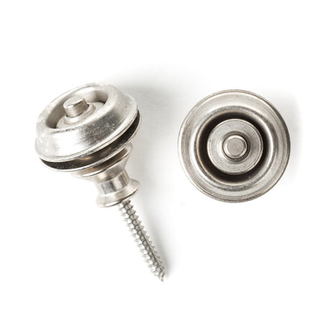 A pair of guitar straplocks with a vintage nickel finish on a white background