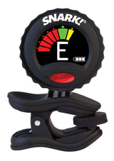 The image shows a SNARK clip-on electronic tuner with a circular LCD displaying a chromatic interface. It features a red power button, a color-coded meter (red, yellow, green) indicating flat, in tune, or sharp, and the letter “E” showing the detected note. The black clip attaches to stringed instruments, and a battery icon is visible. Known for accuracy and convenience, it tunes all 12 chromatic notes.