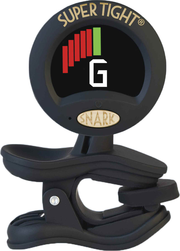 The image shows a Snark Super Tight clip-on guitar tuner with a digital screen displaying the note "G." It features a black clip for attaching to a guitar headstock, red and green tuning indicators, and a compact design. This popular tuner detects vibrations to help musicians accurately tune string instruments quickly and conveniently.