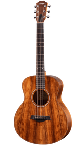 The image shows a beautiful Taylor steel-string acoustic guitar with a medium-sized Grand Auditorium body. It features a rich koa or mahogany wood grain with amber tones, chrome tuning machines, a dark wood bridge with a compensated saddle, a traditional round soundhole with a decorative rosette, and a dark ebony or rosewood fretboard with dot markers. This high-quality instrument is suited for recording, performing, or serious playing.