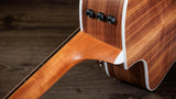 The image shows a high-quality wooden guitar stand or neck support featuring contrasting light and dark wood grains. It has three black tuning peg-style knobs on a curved, ergonomic vertical support. The polished, smooth finish and clean lines highlight professional craftsmanship. Functional hardware suggests adjustability. This premium accessory combines aesthetics and utility, ideal for acoustic or electric guitars and appreciated by serious musicians and collectors.
