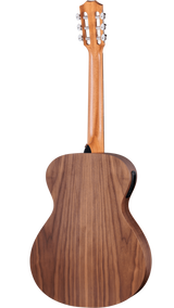 The image shows the back of a full-size acoustic-electric guitar with a walnut or similar wood body featuring distinctive grain and a lighter wood neck. It has six chrome tuning pegs on a traditional headstock and built-in electronics, including a battery compartment or control panel, for amplified play. The guitar has a polished, natural finish and a classic curved waist design, suitable for both beginners and experienced players.