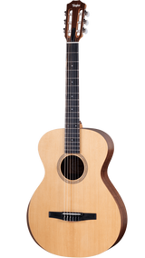 The image shows a Taylor classical guitar with a natural wood top and darker back and sides. It features a wide neck with a dark fretboard, six nylon strings, a slotted headstock with chrome tuners, and a black tie-block bridge. The round sound hole has a decorative rosette. This nylon-string acoustic guitar likely belongs to Taylor’s classical line, showcasing traditional design and craftsmanship.