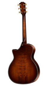 The image shows the back view of a classic acoustic guitar with a rich brown wood finish and prominent wood grain patterns. It features a traditional headstock with six gold or brass tuning pegs, three on each side. The body has decorative binding around the edges, highlighting its refined craftsmanship. The striking wood grain suggests premium figured tonewood, indicating a mid to high-end acoustic guitar.