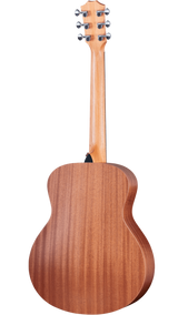 The image shows the back of a full-size acoustic guitar with a warm, reddish-brown wooden body featuring visible grain. It has a long wooden neck leading to a headstock with six dark tuning pegs arranged 3+3. A strap button is visible where the neck meets the body. The guitar has a classic dreadnought shape with a natural, clear-coated finish highlighting the wood’s texture and craftsmanship.