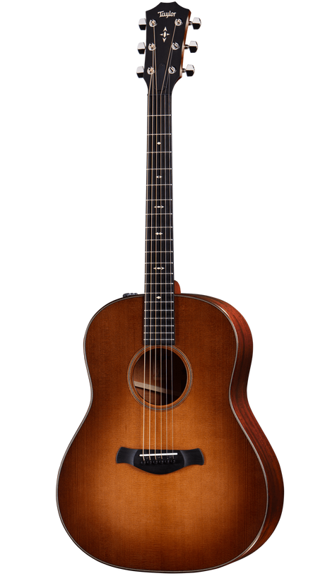 The image shows a beautiful Taylor acoustic steel-string guitar with a classic dreadnought body. It features a sunburst finish transitioning from amber center to dark edges, a light-colored spruce top, darker wood back and sides, chrome tuning pegs, black bridge, decorative fretboard inlays including a distinctive 12th fret pattern, and light binding around the body. The Taylor logo is visible on the headstock.