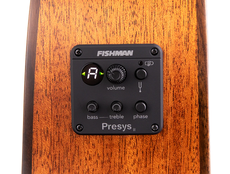 The image shows a Fishman Presys II acoustic guitar preamp system installed in the side of a guitar. Visible features include a digital tuner display, volume knob, bass and treble EQ controls, phase switch, low battery indicator, and the Fishman branding. This onboard preamp allows acoustic guitarists to amplify and shape their tone while providing a built-in tuner for live or recording use.