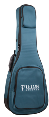 The image shows a teal and black padded gig bag from Teton Guitars, designed to carry and protect a full-size acoustic guitar. It features the "TETON GUITARS" logo on the front pocket, multiple zippered compartments, padded shoulder straps, and durable fabric construction, providing ample storage for accessories like picks, strings, and tuners.
