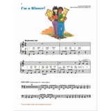 The image shows a page titled "I'm a Winner!" from a children's piano method book. It features two kids celebrating with brass instruments and a trophy. The page includes sheet music marked "Moderately fast" in 4/4 time, with piano notation and lyrics about winning activities. A duet part is provided, along with a note on playing pairs of eighth notes long-short, encouraging beginner ensemble play.