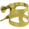 The image shows a brass or gold-colored saxophone ligature designed for an alto saxophone, marked "ALTO." It features a circular band with cut-out sections, a side screw for tightening, and secures the reed to the mouthpiece. The design allows the reed to vibrate freely, ensuring proper positioning for sound quality. This professional-grade ligature likely has a lacquered finish typical of quality woodwind accessories.