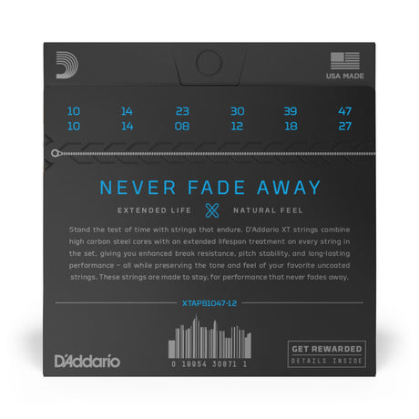 The image shows a package of D'Addario XTAPB1047-12 12-string acoustic guitar strings. It features string gauges in blue along the top, the "NEVER FADE AWAY" slogan, and highlights "EXTENDED LIFE" and "NATURAL FEEL." The packaging notes the strings’ high carbon steel cores for durability and tone, the USA-made label with the D'Addario logo, a barcode, product code, and info on the loyalty program inside.
