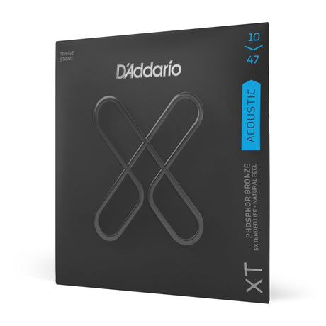 The image shows a package of D'Addario XT 12-string acoustic guitar strings, light gauge (10-47). The strings are phosphor bronze wound and designed for extended life and natural feel. The packaging features D'Addario’s black design with blue accents and the crossed "X" logo, clearly displaying the product and specifications. This premium set offers durability without sacrificing tone.