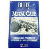 The image shows a package of Blitz Metal Care, a non-toxic cleaning and polishing solution for metal musical instruments. Established in 1912, Blitz’s Metal Care is designed to clean, shine, and protect silver, brass, gold, and plated instruments. The packaging features a saxophone and sheet music, highlighting its use for brass and metal wind instruments. Made in the USA, it’s essential for instrument maintenance.