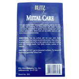 The image shows a Blitz Metal Care cloth (Stock No. 303) by Blitz, a brand established in 1912. This specialized two-part cloth is designed for cleaning and polishing unlacquered soft metal brass instruments like trumpets and trombones. Safe for gold, silver, brass, and plated metals, it removes tarnish and restores shine. The packaging warns against use on lacquered surfaces, recommending Blitz Gloss Care instead.