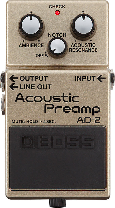 The image shows a Boss AD-2 Acoustic Preamp pedal for acoustic guitars. It features three control knobs: Ambience, Notch, and Acoustic Resonance. There is a red "CHECK" LED, labeled OUTPUT, INPUT, and LINE OUT jacks, and a large black footswitch with the Boss logo and "MUTE: HOLD > 2SEC" text. The pedal is champagne-colored and enhances acoustic tone with effects, feedback control, and resonance.