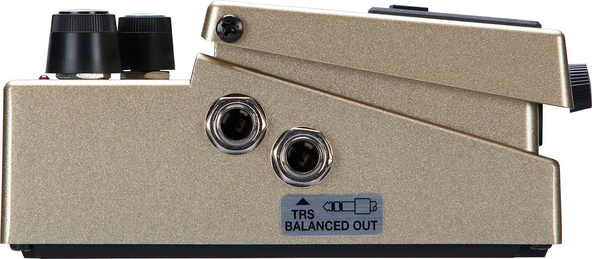 The image shows a professional audio interface with a champagne-colored metal casing, featuring two XLR input jacks, a "TRS BALANCED OUT" label, and control knobs. This device connects microphones and instruments to computers, converts analog signals to digital, and provides high-quality audio input/output, making it essential for music production and recording in studios.