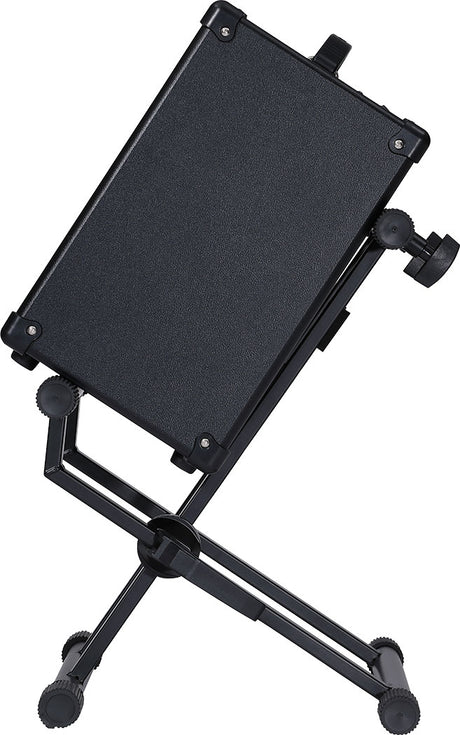 The image shows a black, adjustable music stand with a tray for sheet music or tablets, an articulating arm for height and angle adjustments, and a sturdy tripod base with adjustable legs. It features multiple knobs for positioning flexibility and durable construction, making it ideal for musicians of all genres and skill levels to comfortably view their music during practice or performance.