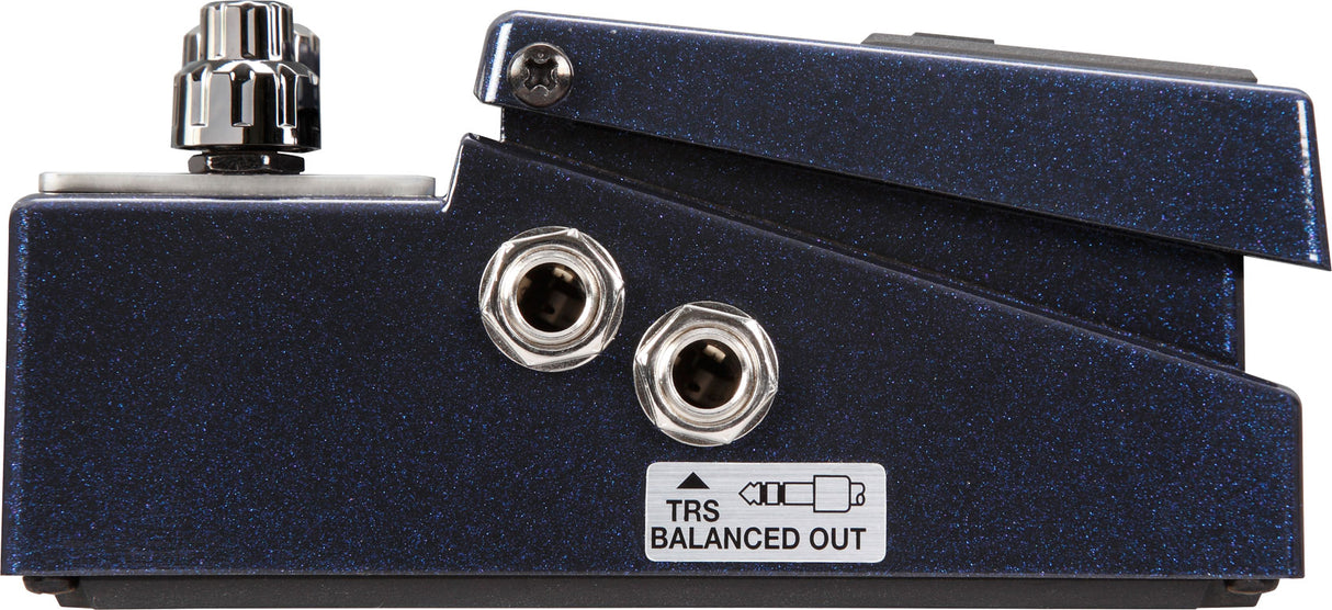The image shows a guitar effects pedal’s side/back panel featuring two 1/4" audio jacks, a control knob, and a TRS Balanced Out label. It has a dark blue sparkle finish and sturdy metal construction. This high-quality pedal, likely for distortion or tone shaping, is designed for both live performance and studio use, indicating a boutique or premium build.