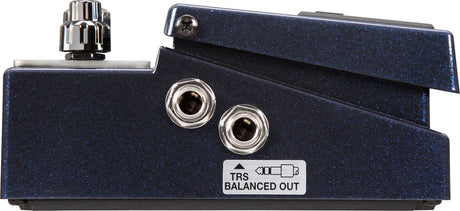 The image shows a guitar effects pedal’s side/back panel featuring two 1/4" audio jacks, a control knob, and a TRS Balanced Out label. It has a dark blue sparkle finish and sturdy metal construction. This high-quality pedal, likely for distortion or tone shaping, is designed for both live performance and studio use, indicating a boutique or premium build.