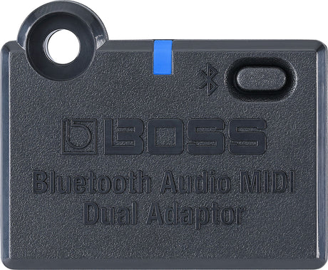 The image shows a BOSS Bluetooth Audio MIDI Dual Adaptor, a compact, dark gray device with BOSS branding, Bluetooth symbol, blue accent strip, power button, and mounting hole. It wirelessly transmits audio and MIDI data, enabling musicians to connect instruments to speakers, apps, or devices for practice, recording, or performance, blending modern wireless tech with reliable musical gear.