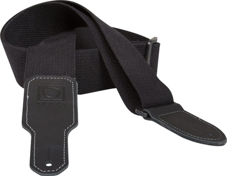 The image shows a black guitar strap made of durable fabric with a wide, padded shoulder section for comfort. It features adjustable metal buckles, leather or synthetic leather end tabs with white contrast stitching, and a visible BOSS logo on one end. Designed to support the instrument while standing, this versatile strap combines functionality and style, suitable for various guitar styles and performance settings.