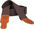 The image shows a guitar strap made of brown cotton webbing with orange/tan leather ends featuring white stitching and the embossed "BOSS" logo. It has an adjustable buckle on the right for length adjustment. Designed for durability and style, this strap supports guitarists playing standing up by distributing the instrument's weight. The BOSS branding indicates it’s from the well-known Roland/BOSS music equipment brand.