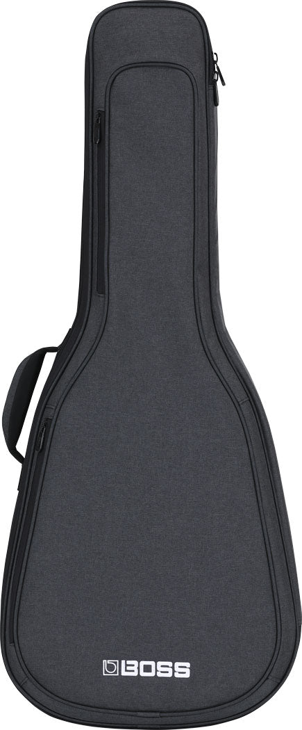The image shows a dark gray BOSS guitar gig bag with a padded, soft case design shaped for acoustic or electric guitars. It features multiple zippered compartments, including a main guitar compartment and a top accessory pocket, a carrying handle, and BOSS branding at the bottom. The professional textured fabric exterior offers lightweight protection, highlighting BOSS’s expansion from effects pedals into guitar accessories.