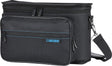 The image shows a black BOSS gig bag designed for transporting BOSS guitar effects pedals and small electronic music gear. It features the blue BOSS logo, multiple zippered compartments, a hexagonal textured front panel, blue accent stitching, and an adjustable shoulder strap. This professional bag helps musicians organize and protect their equipment for gigs, rehearsals, or studios.