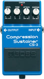 The image shows a blue BOSS CS-3 Compression Sustainer guitar effects pedal. It has four knobs—LEVEL, TONE, ATTACK, and SUSTAIN—for controlling volume, tone, compression attack, and sustain. A red "CHECK" LED lights when active. Input and output jacks are on the sides, and a large black footswitch with the BOSS logo turns the effect on/off. It compresses the guitar signal to even volume and add sustain.