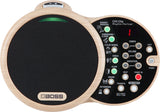 The image shows a BOSS DR-01S Rhythm Partner, an electronic drum machine with a distinctive dual-circle light wood design. The left side features a large mesh practice pad with the BOSS logo. The right side has a control panel with percussion instrument buttons, LED indicators, tempo, volume, variation knobs, function buttons, power, exit, and a small LCD display. It’s designed for rhythm creation and practice.