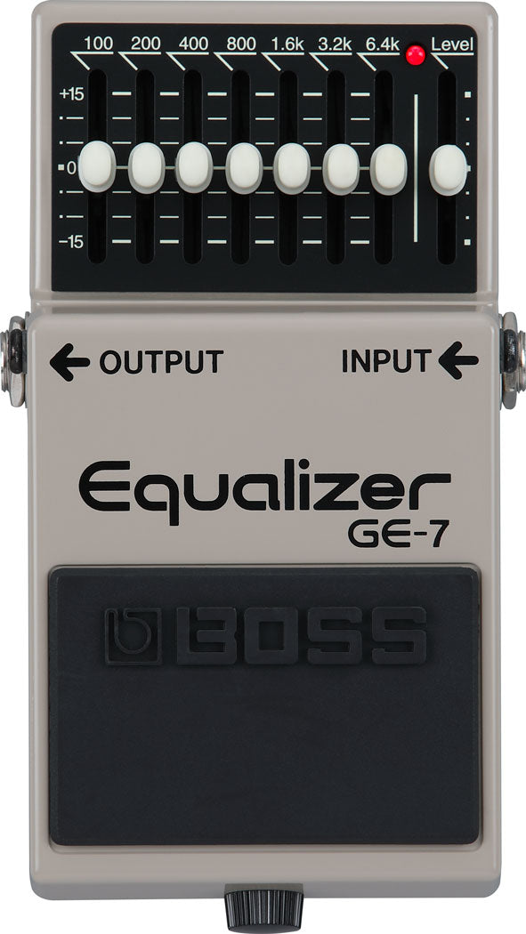 The image shows a Boss GE-7 Equalizer pedal, a popular 7-band guitar effects pedal with sliders for 100Hz to 6.4kHz frequencies, each adjustable ±15dB. It includes a master Level control, 1/4" input/output jacks, and a classic gray/silver casing. Used by guitarists and bassists to shape tone, reduce feedback, and boost frequencies for live and studio settings.