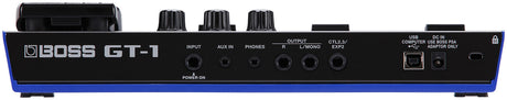 The image shows a BOSS GT-1 guitar effects processor, a compact multi-effects pedal from BOSS (Roland). It features guitar input, AUX IN, headphone out, main outputs, control jacks, USB port, DC power input, and a power switch. The top panel has three rotary knobs. Designed for versatile guitar effects, amp modeling, and sound processing, the GT-1 is ideal for practice, recording, and live use.