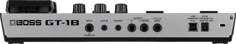 The image shows the rear panel of a Boss GT-1B bass guitar multi-effects processor pedal. It includes INPUT and AUX IN jacks, a PHONES jack, R and L/MONO OUTPUTs, CTL2,3/EXP2 control jacks, a USB port, DC IN power jack, and a power switch. This compact digital unit offers various effects and USB connectivity for recording and editing, made by the well-known Boss brand.