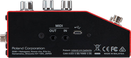The image shows the back panel of a Roland electronic music device with MIDI IN and OUT ports, a USB port, and an audio output jack. It has three metallic control knobs on top and a black casing with red trim. The device, made by Roland in Malaysia, features certification marks and a compact, rectangular design, suggesting it is a MIDI controller, audio interface, or compact synthesizer module for modern music production setups.