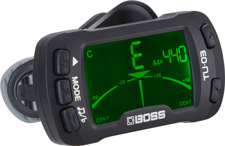 The image shows a BOSS TU-30 clip-on tuner with a bright green LCD displaying a "C" note and "A4=440" reference. It has a needle tuning meter centered at zero cents, multiple control buttons, and a black clip for attaching to instrument headstocks. Known for accurate vibration detection, it’s popular among guitarists and bassists for quick tuning in noisy settings.