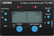 The image shows a BOSS TU-30 Tuner & Metronome featuring a digital LCD displaying "E4" at 440 Hz in chromatic mode. It includes Accu-Pitch tuning with a meter from -50 to +50 cents, dual tuner and metronome functions, blue control buttons, red flat and sharp indicators, a built-in mic for acoustic tuning, and an input jack for electric instruments. This device aids musicians in precise tuning and timing.