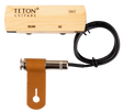 The image shows a TETON Guitars THM2 acoustic guitar pickup and preamp system. It includes a light wood preamp/control box with "VOLUME" and "MIC" controls, a black pickup cable, a chrome 1/4" output jack, and a brown leather mounting strap. Designed to amplify acoustic guitars, the hybrid system combines pickup and microphone functions, with a wooden preamp for an aesthetic fit inside the guitar.