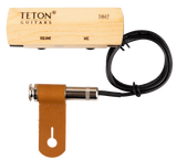 The image shows a TETON Guitars THM2 acoustic guitar pickup and preamp system. It includes a light wood preamp/control box with "VOLUME" and "MIC" controls, a black pickup cable, a chrome 1/4" output jack, and a brown leather mounting strap. Designed to amplify acoustic guitars, the hybrid system combines pickup and microphone functions, with a wooden preamp for an aesthetic fit inside the guitar.