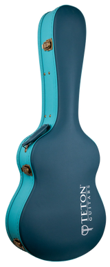 The image shows a hard shell guitar case from Teton Guitars in a teal/turquoise color with gold metal hardware. It features the classic acoustic guitar shape and the "TETON GUITARS" logo in white. Designed for protection, this sturdy case offers secure storage and transport, shielding acoustic guitars from impacts and environmental damage better than soft gig bags.
