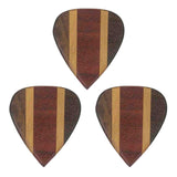 The image shows three premium wooden guitar picks made from laminated wood with layered, striped patterns. They feature alternating dark and light wood strips, likely walnut or ebony and maple or birch. These artisanal picks have smooth edges and polished finishes, offering both aesthetic appeal and a warmer tone favored by acoustic players and collectors.