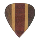 The image shows a handcrafted wooden guitar pick with a laminated design featuring a reddish-brown center, lighter wood strips on the sides, and darker edges. Its distinctive striped pattern highlights different wood types, making it a premium accessory valued for natural materials, warm tone, comfortable feel, and unique aesthetics that blend musical function with artisanal craftsmanship.